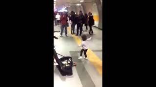 Niña bailando al ritmo de la música en el metro